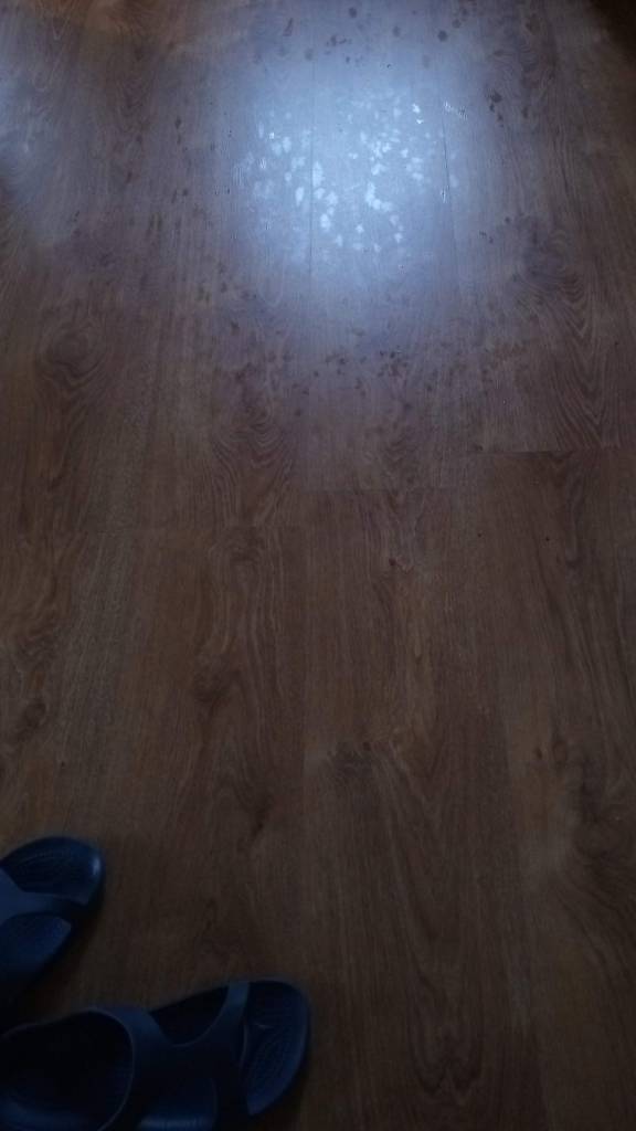 A photo showing what looks like dried up water droplets on the floor